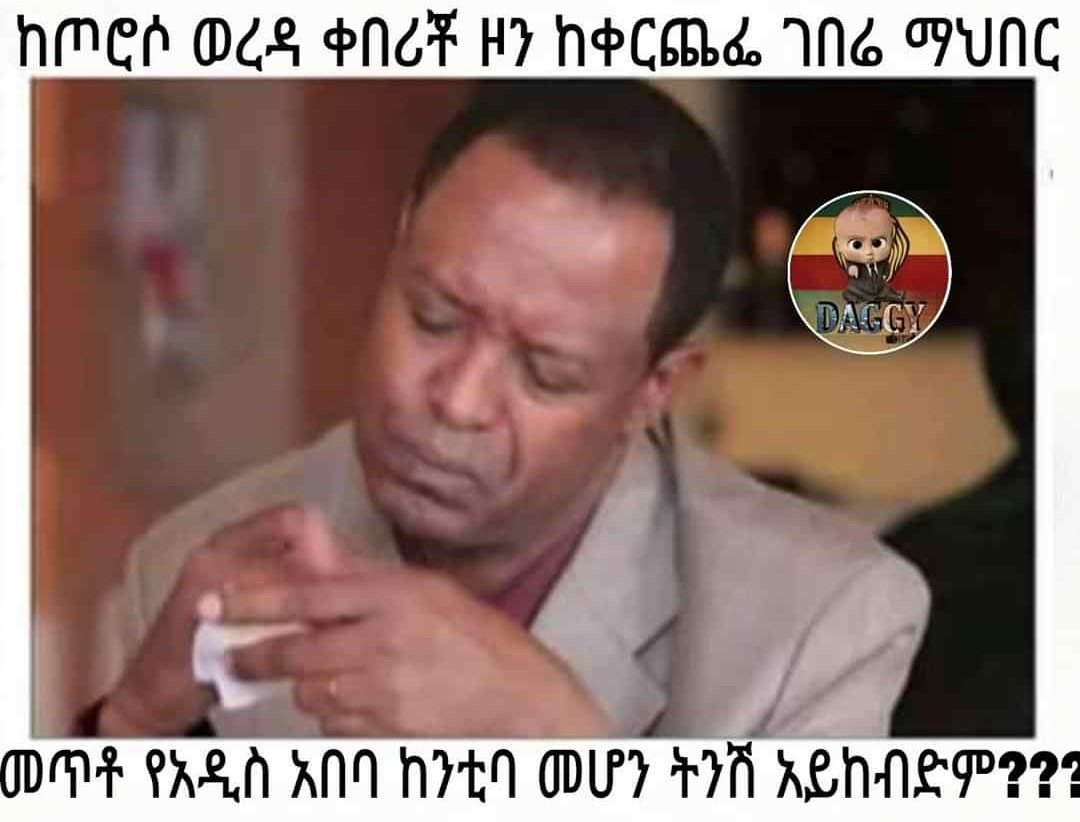 a man in a suit and tie is holding a cigarette